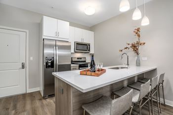 a kitchen with stainless steel appliances and a white counter top at Beekman on Broadway, Ann Arbor